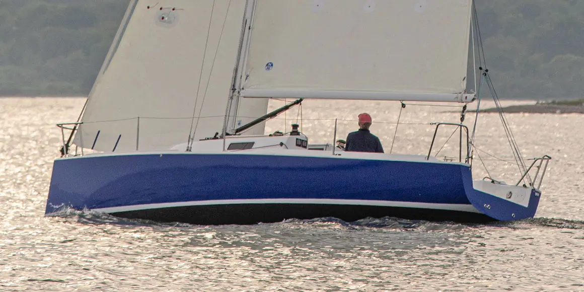 Older solo sailor on a J-Boat J/9 sailboat.