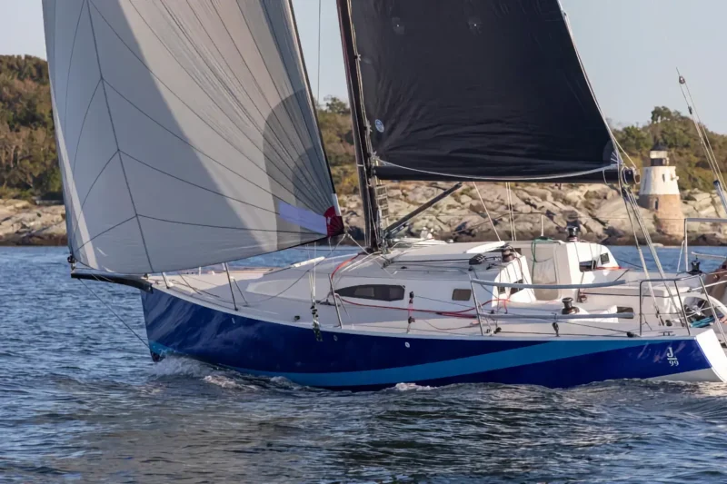 J-Boat J99 sailboat with open sails on water.