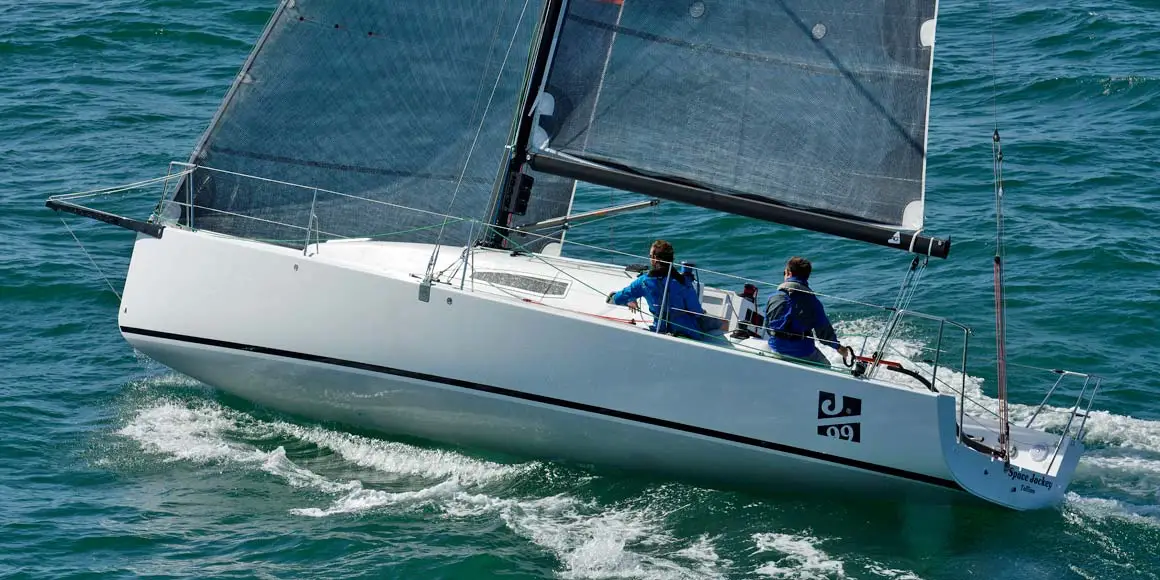 Two person crew on a J-Boat J99 sailboat.