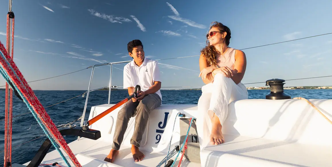 A young couple on Agent 99, a J-Boat J99 sailboat.