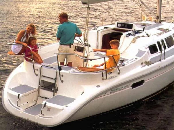 Family sailing on a 1997 Hunter 336 sailboat.