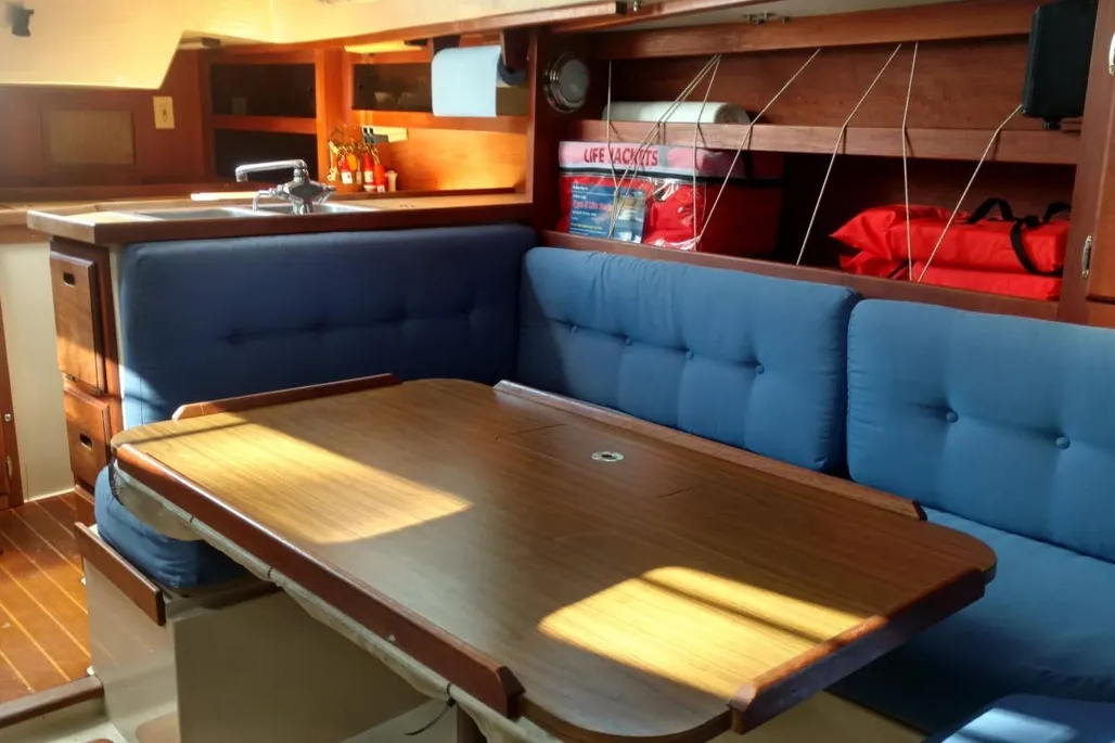 1984 Catalina 38 sailboat interior salon table and bench seating.